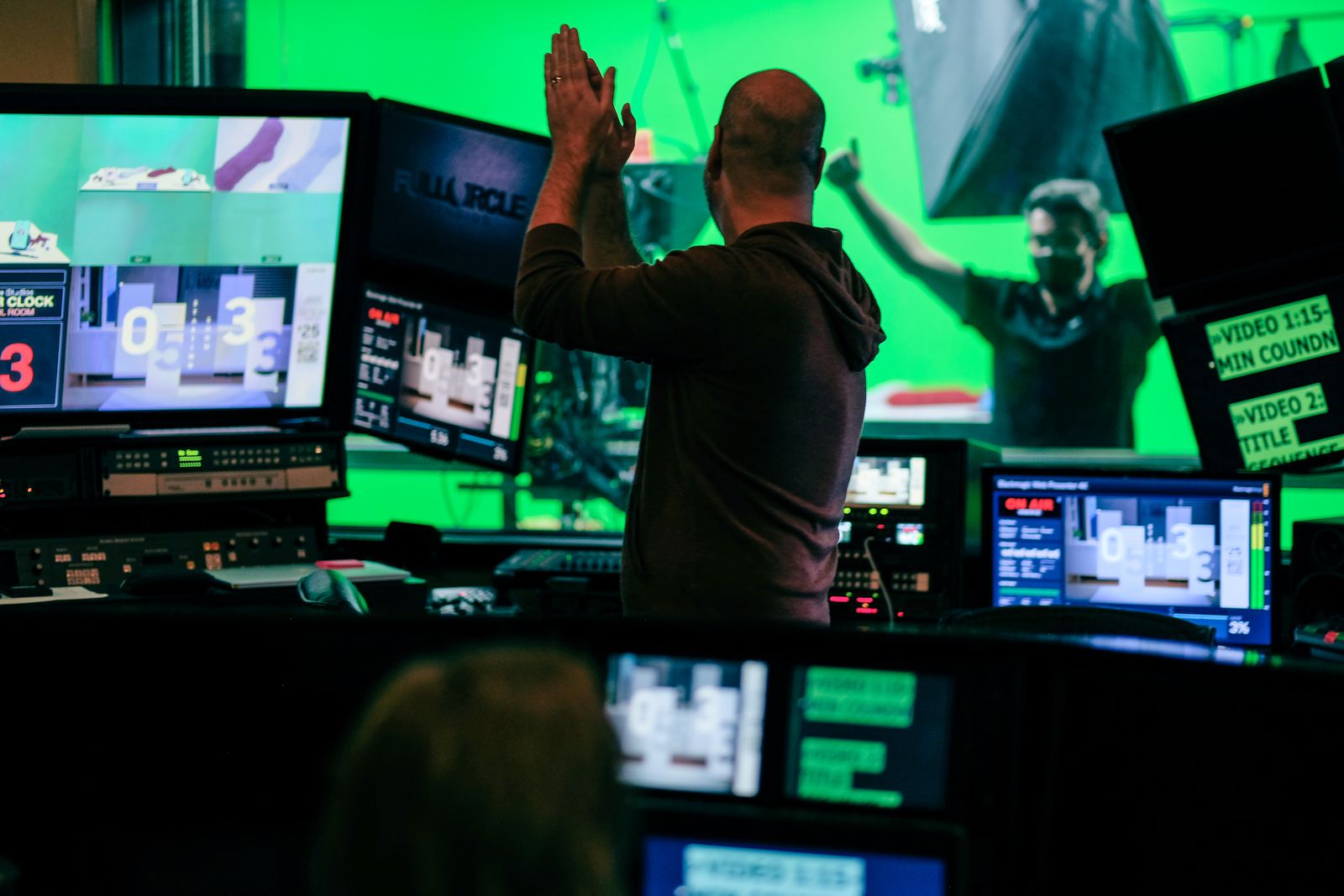 Crew celebrating in the control room during a green screen shoot